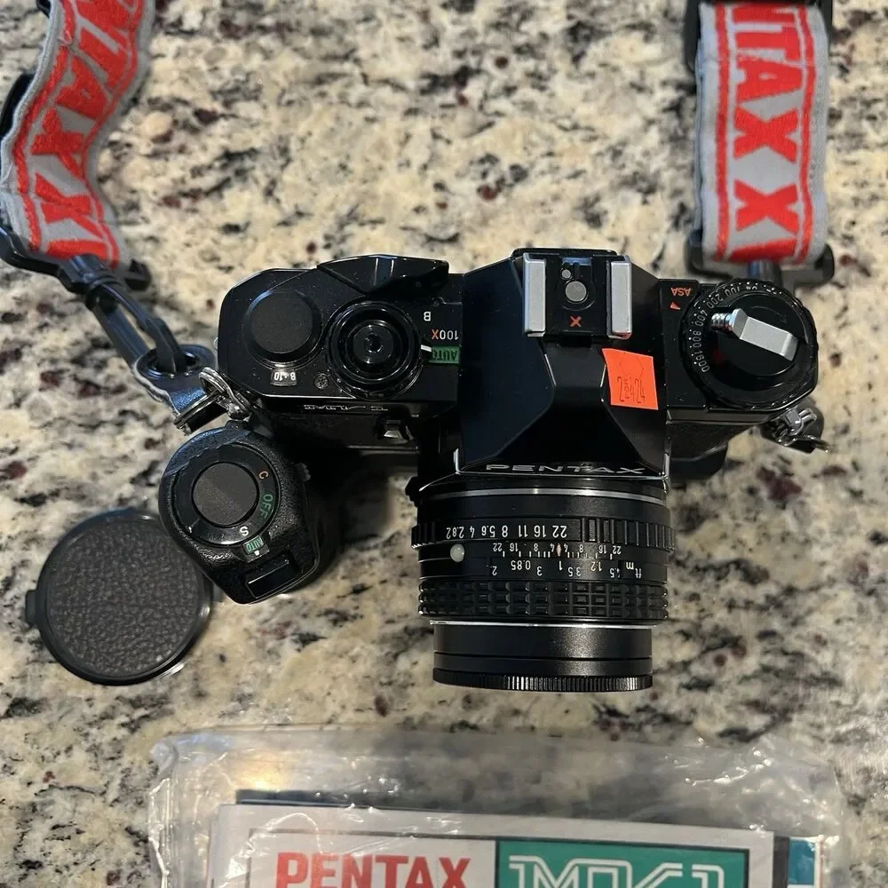 Asahi Pentax MV-1 35mm SLR Film Camera With lens, Mount, Strap and documents